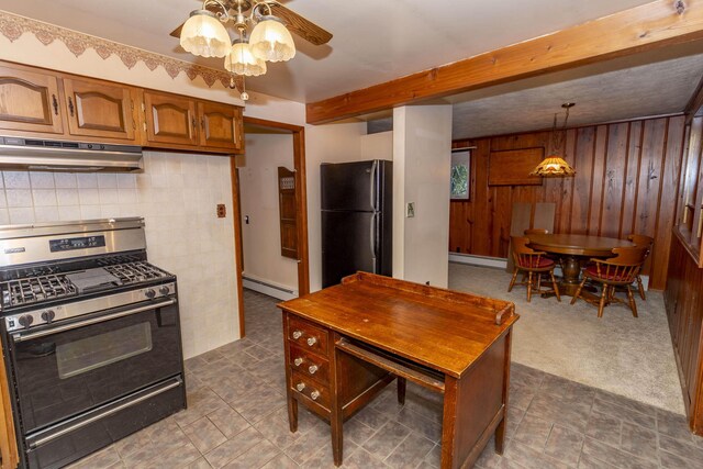 21734 N Channel Pkwy, Edwardsburg, MI 49112 - kitchen featuring stainless steel gas range oven, under cabinet range hood, freestanding refrigerator, a baseboard heating unit, and ceiling fan