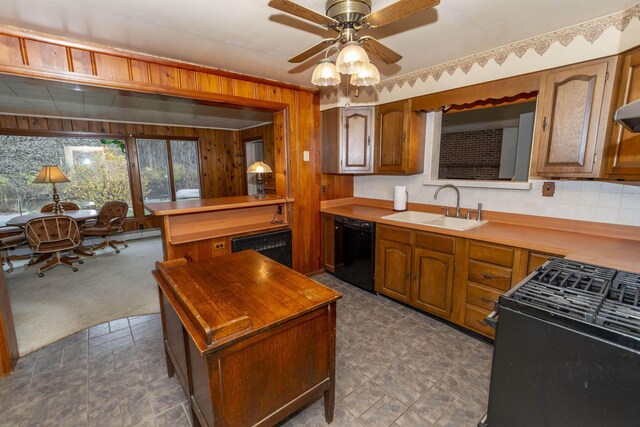 21734 N Channel Pkwy, Edwardsburg, MI 49112 - kitchen with black appliances, wooden walls, a sink, brown cabinetry, and ceiling fan