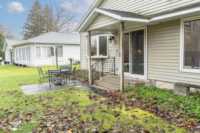 21734 N Channel Pkwy, Edwardsburg, MI 49112 - entrance to property with a patio and a yard