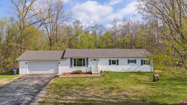 ranch-style house with a garage and a front lawn