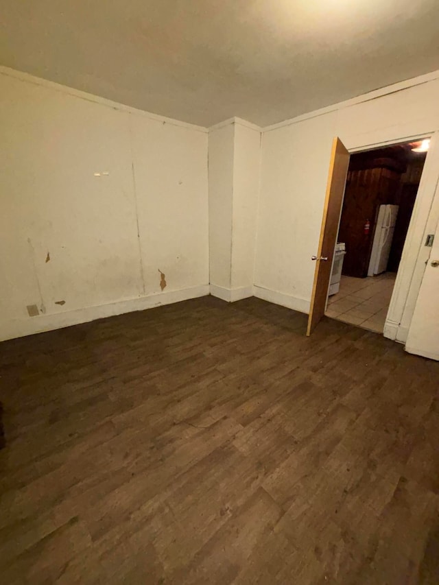 unfurnished room with dark wood-type flooring