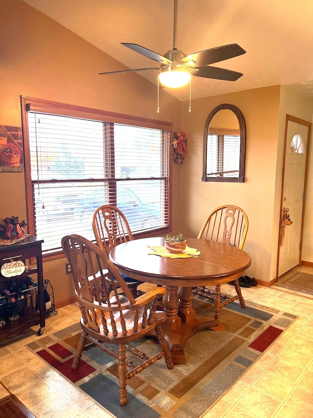 dining area with tile patterned flooring, ceiling fan, and lofted ceiling