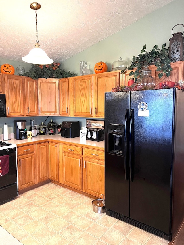 kitchen with lofted ceiling, light tile patterned flooring, pendant lighting, a textured ceiling, and black appliances