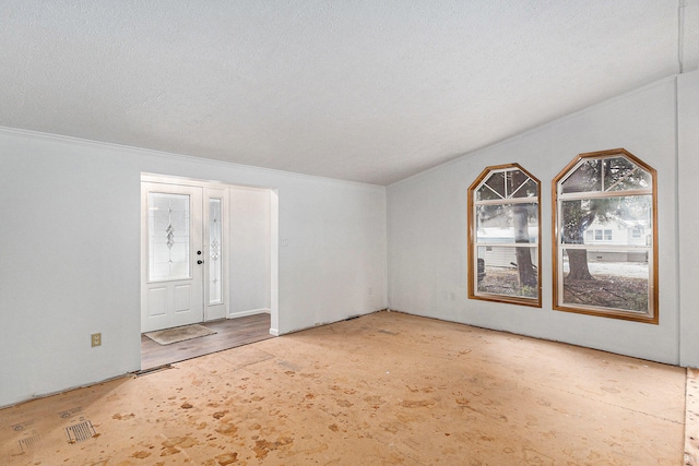 entrance foyer with wood-type flooring, a textured ceiling, and ornamental molding