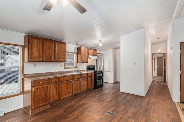 kitchen featuring black range oven, a textured ceiling, sink, and dark wood-type flooring