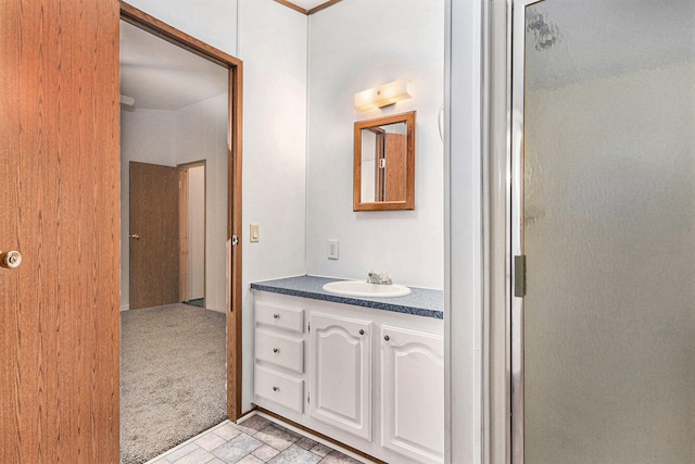 bathroom featuring vanity and a shower with door