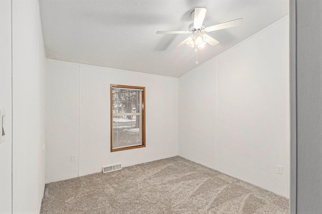 empty room with carpet flooring, a textured ceiling, and ceiling fan