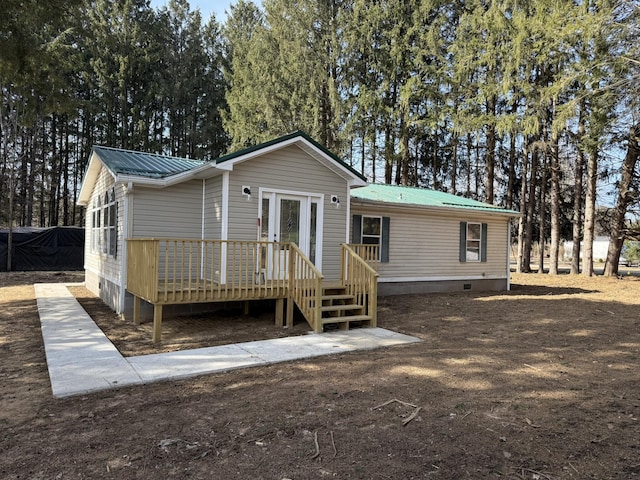 view of front of home with crawl space, metal roof, and a wooden deck