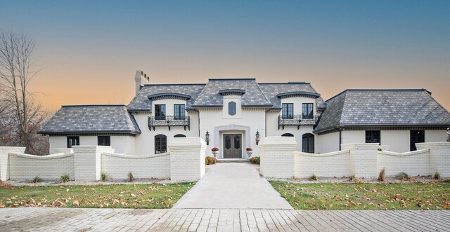 french country home with a balcony