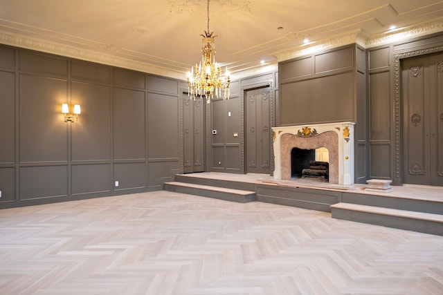 unfurnished living room with a notable chandelier, ornamental molding, a premium fireplace, and light parquet flooring