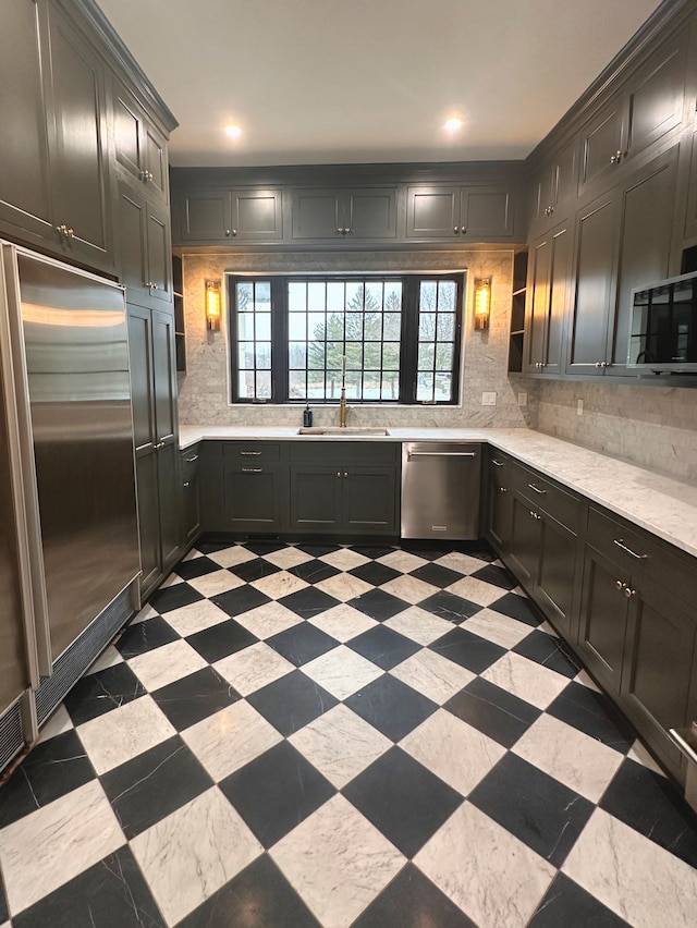 kitchen featuring appliances with stainless steel finishes, sink, and backsplash