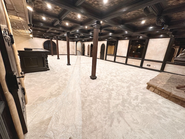 recreation room featuring coffered ceiling, beam ceiling, carpet floors, and ornate columns