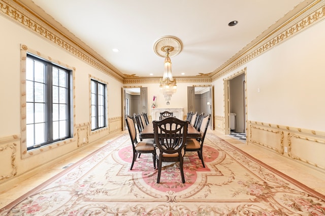 dining space with ornamental molding and a chandelier