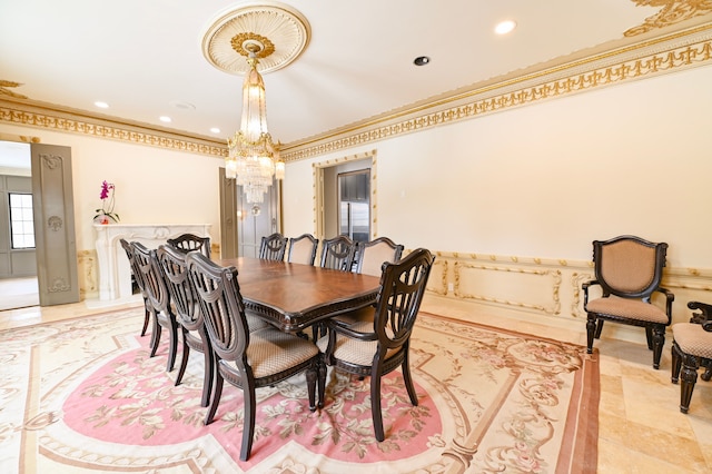 dining space featuring ornamental molding and an inviting chandelier