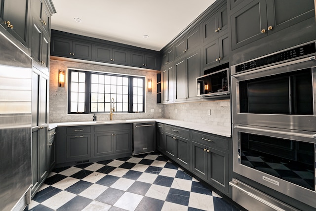 kitchen with tasteful backsplash, appliances with stainless steel finishes, and sink