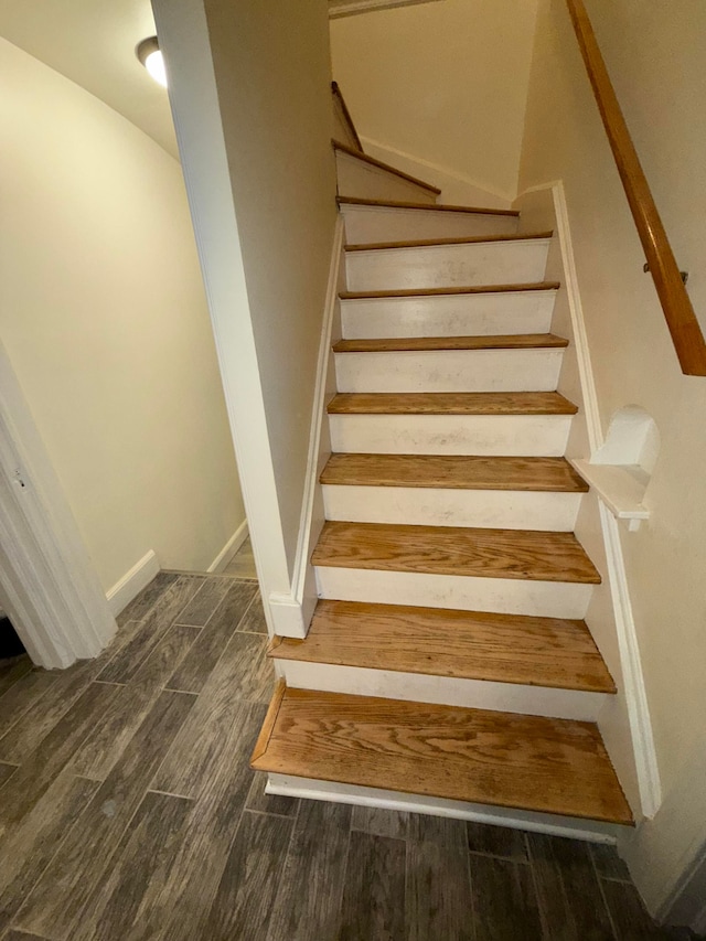 staircase with hardwood / wood-style floors