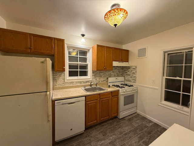 kitchen with decorative backsplash, sink, extractor fan, and white appliances