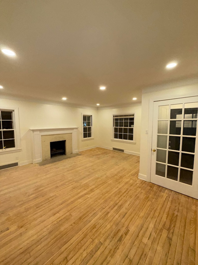 unfurnished living room with light hardwood / wood-style flooring