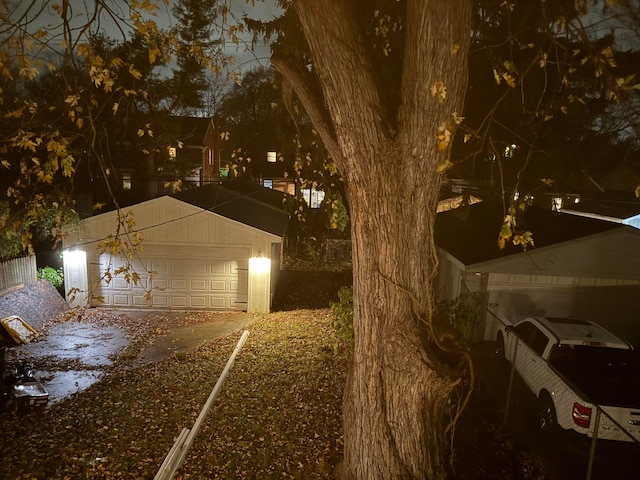 exterior space with a garage and an outbuilding