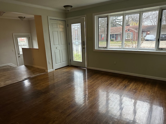 foyer with dark wood-type flooring and ornamental molding