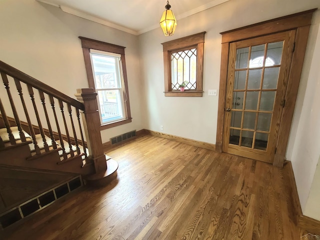 entryway featuring crown molding and wood-type flooring