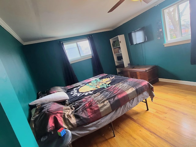 bedroom with ceiling fan, hardwood / wood-style floors, and crown molding