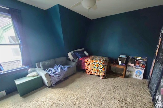 bedroom featuring ceiling fan, carpet, and multiple windows