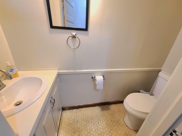 bathroom featuring toilet and vanity