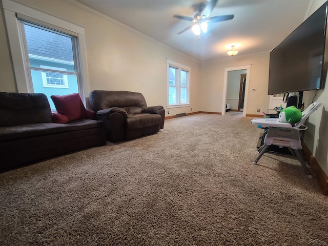 carpeted living room featuring ceiling fan and ornamental molding