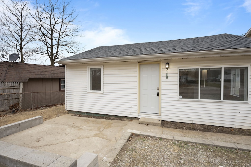 view of exterior entry with a patio