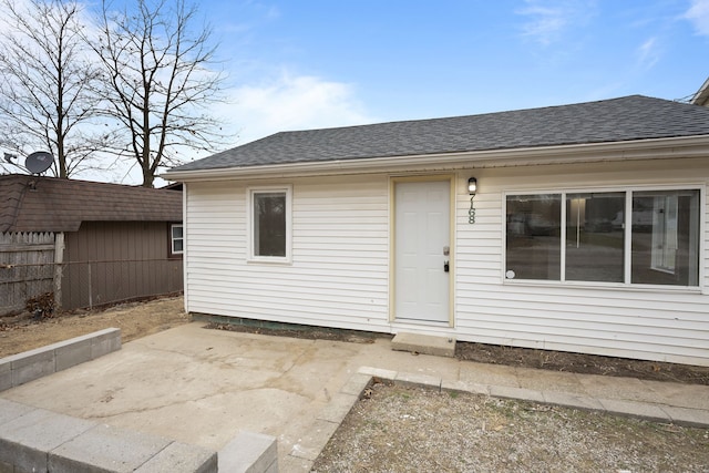 view of exterior entry with a patio