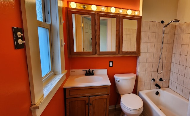 full bathroom featuring vanity, toilet, and tiled shower / bath