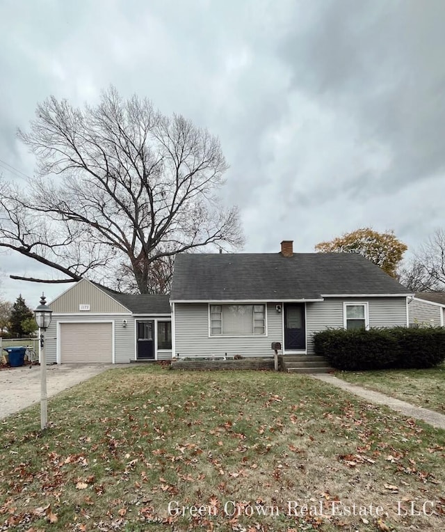 ranch-style house featuring a garage and a front lawn