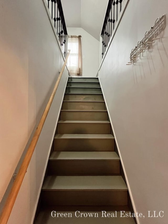 staircase with vaulted ceiling