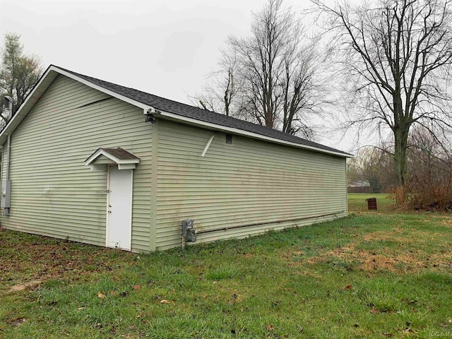 view of side of property with a lawn