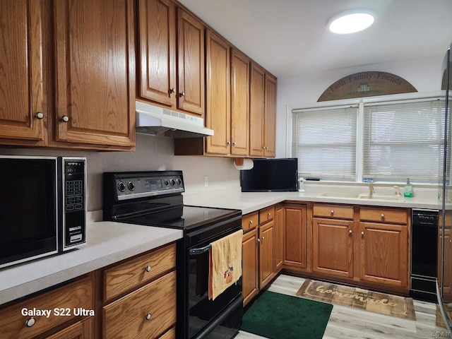 kitchen with light hardwood / wood-style floors, black electric range, and sink