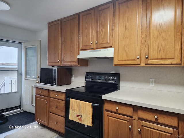 kitchen featuring decorative backsplash and black appliances