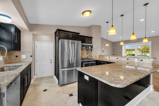 kitchen featuring light stone countertops, appliances with stainless steel finishes, backsplash, and pendant lighting