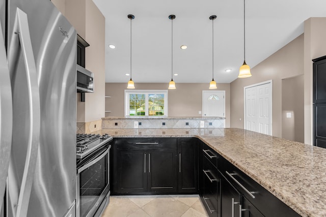 kitchen with light stone countertops, tasteful backsplash, stainless steel appliances, pendant lighting, and light tile patterned floors