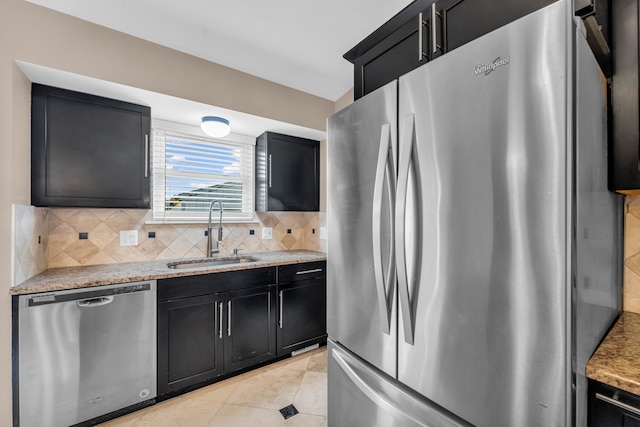 kitchen featuring light tile patterned floors, sink, appliances with stainless steel finishes, and tasteful backsplash