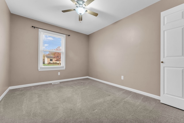 spare room featuring carpet and ceiling fan