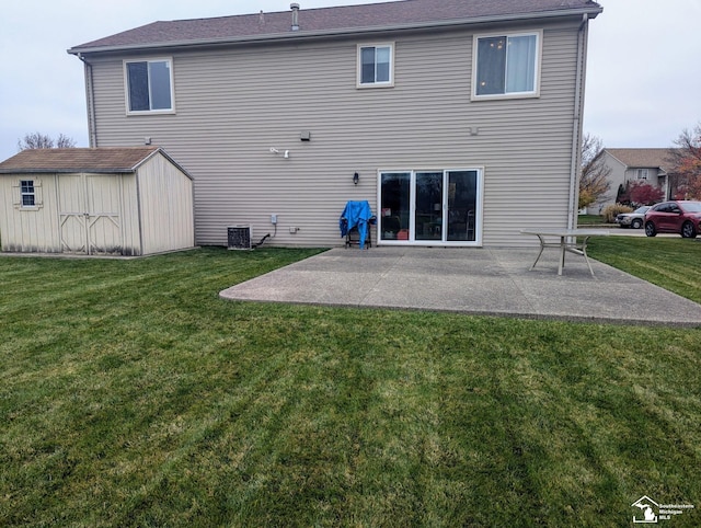 rear view of property featuring central AC, a storage shed, a patio area, and a lawn