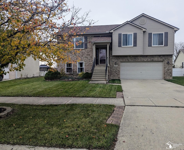 raised ranch with a front lawn and a garage