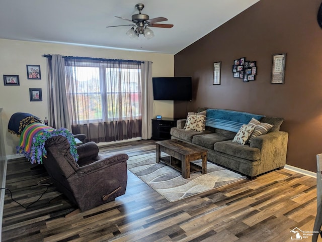 living room featuring ceiling fan, wood-type flooring, and vaulted ceiling