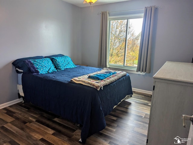 bedroom with ceiling fan and dark wood-type flooring