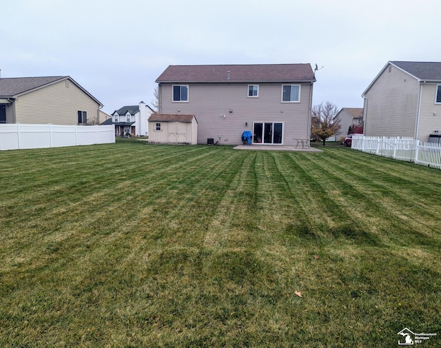 rear view of house featuring a lawn and a patio area