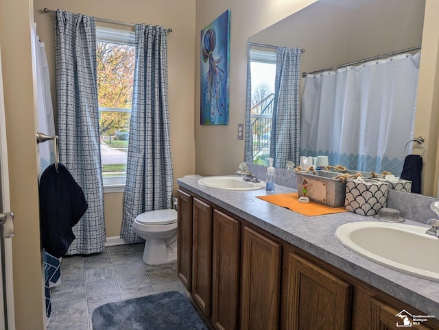 bathroom featuring tile patterned flooring, vanity, and toilet