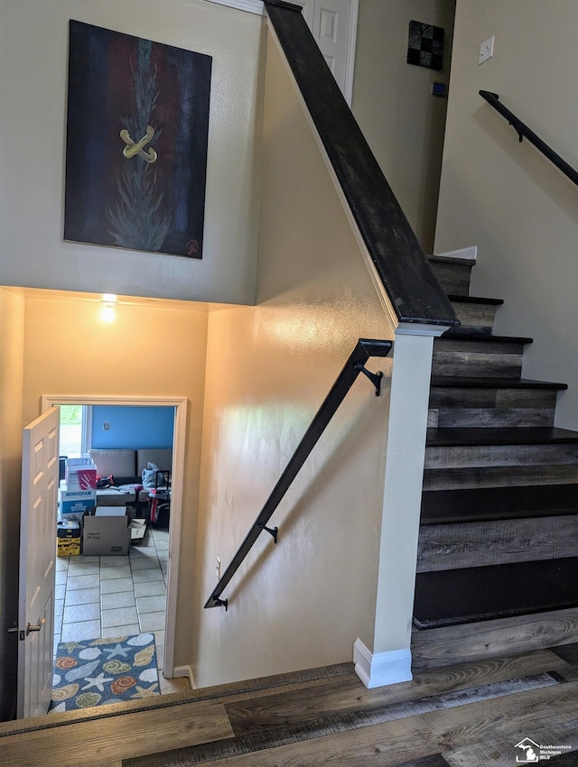 staircase featuring wood-type flooring