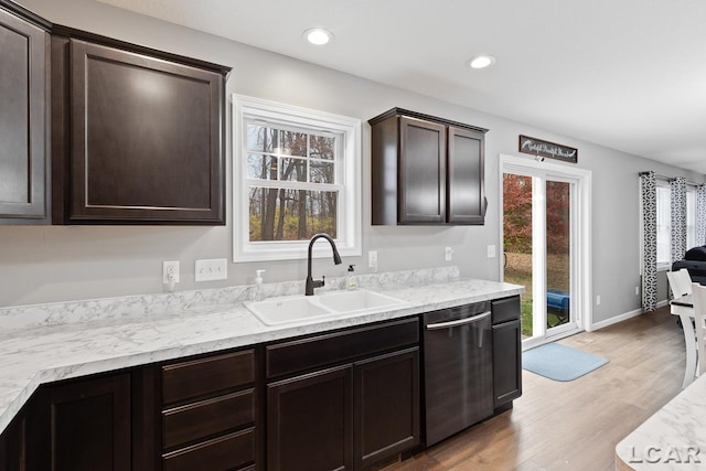 kitchen featuring dishwasher, light wood-type flooring, plenty of natural light, and sink