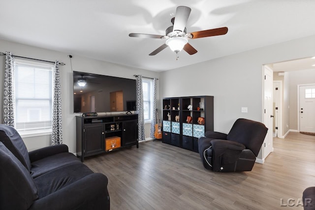 living room with ceiling fan and dark hardwood / wood-style flooring